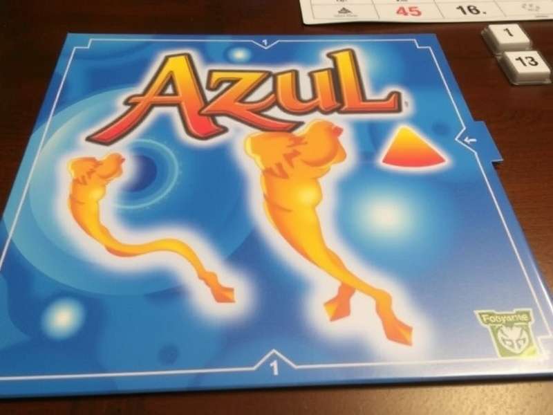 Close-up of colorful Azul tiles being placed on player board